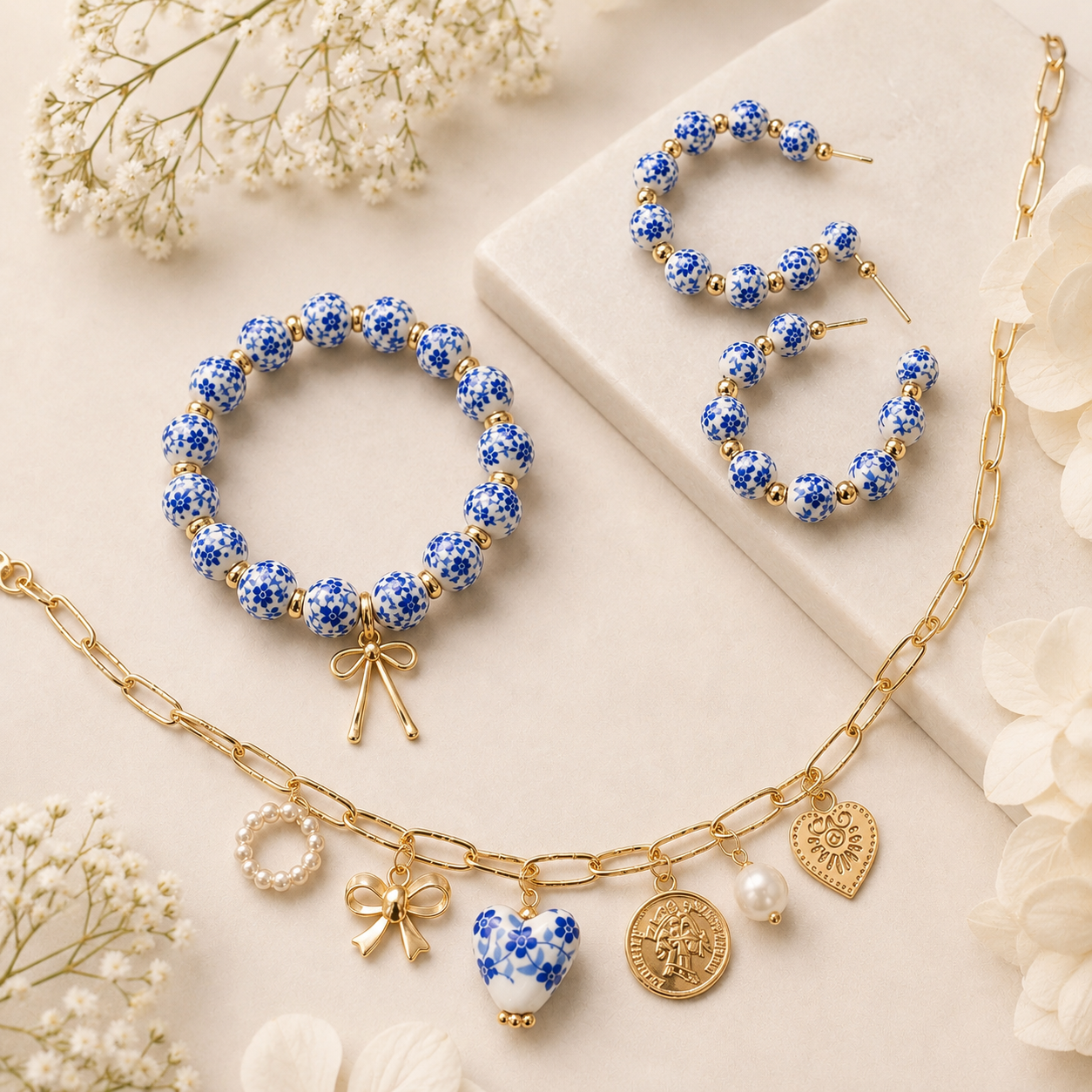 Blue floral charm jewelry set with delicate gold-tone accents