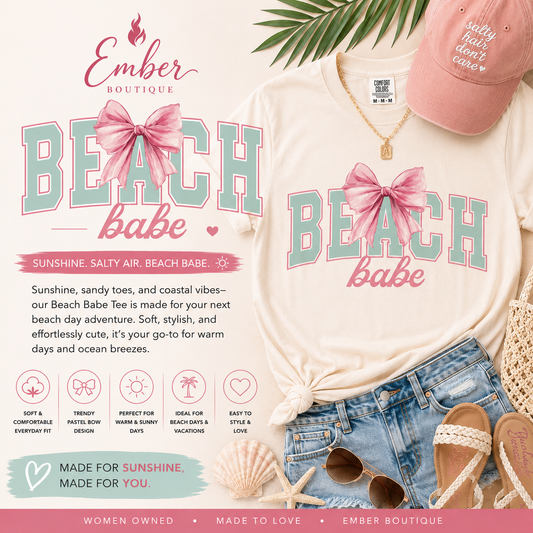 Cream-colored Beach Babe graphic tee featuring pastel blue and pink lettering with a large pink bow design. Styled with layered jewelry and casual summer fashion for a feminine coastal-inspired look. Perfect for beach days, vacations, and warm-weather outfits.