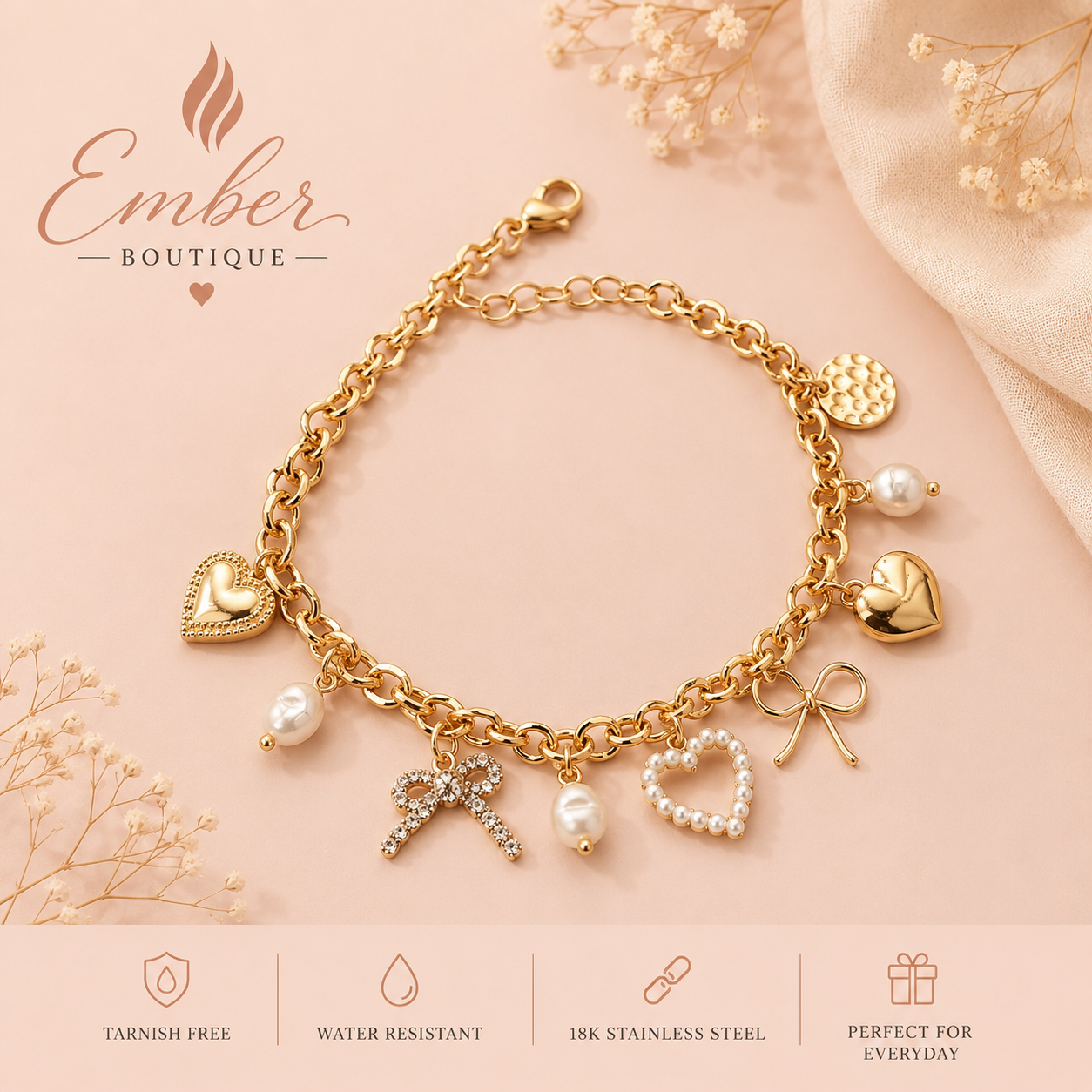 Gold-tone charm bracelet with bow, heart, pearl, and disc charms